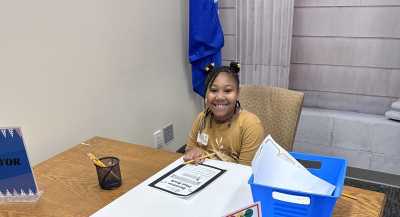 Girl Working at Desk in Workshop