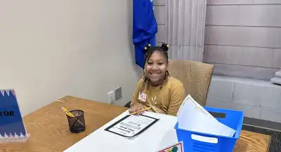 Girl Working at Desk in Workshop